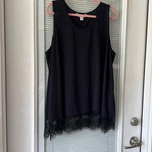 Knit tank top with lace trim. Can be worn by itself or just under another shirt.